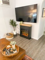 Apartment | Living area | 65-inch Smart TV with cable channels, streaming services