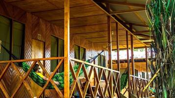 A wooden structure with a herringbone pattern on the walls and a metal railing.
