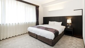 A hotel room with a large bed, a bedside table with a lamp, and a view of the outdoors through sheer curtains. - Racine Home Kyoto SELF CHECK-IN (Kyoto)