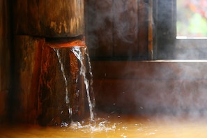 A wooden structure with a water feature.