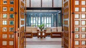 A traditional Japanese-style interior with tatami mat seating, a central wooden table with a plant, and a view through a lattice window. - Paradis d' Ouvea (Ouvea)
