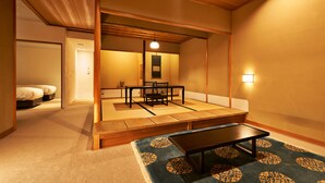 A traditional Japanese room with tatami flooring, a low table, and a futon bed. - Aoi Hotel Kyoto (Kyoto)