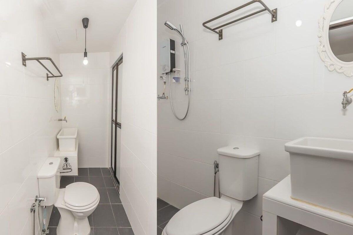 A bathroom with a toilet, bidet, and shower.