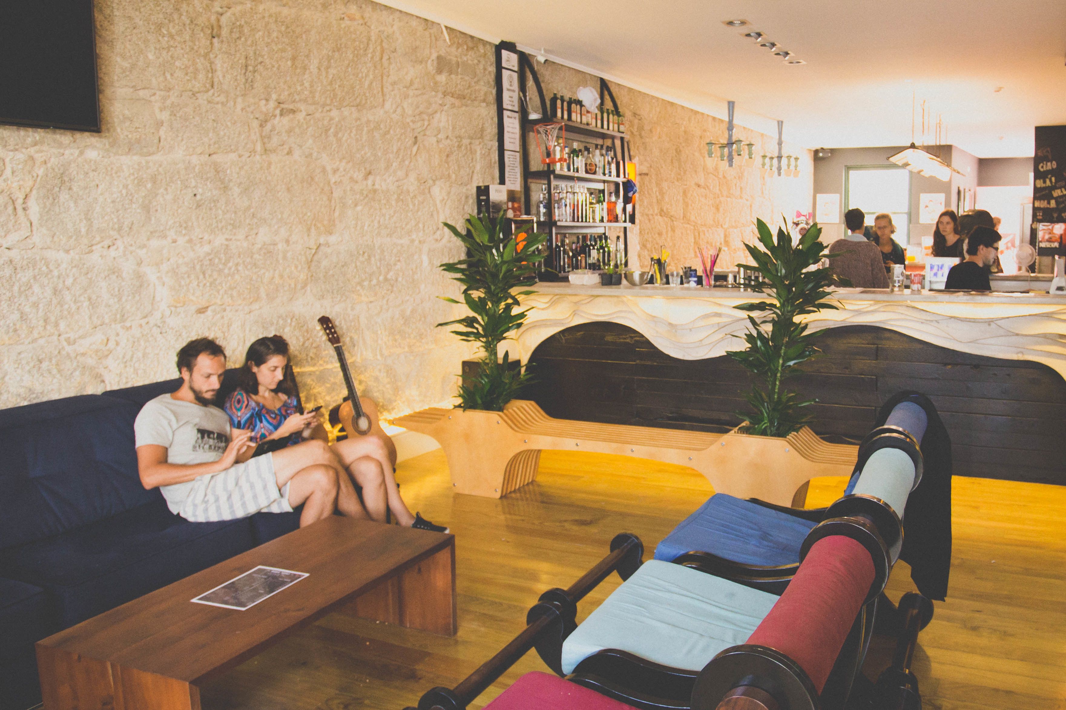 Un'accogliente area relax con un divano, un tavolino in legno e una poltrona reclinabile. Si nota una libreria con diversi oggetti e una piccola pianta.