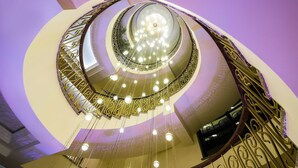A spiral staircase with ornate railings and a central light fixture. - Elegant Hotel & Resort (Tsaghkadzor)