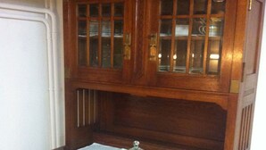 A wooden cabinet with glass doors and a glass dome on top. - 200 Year Old Swiss House (Erlenbach im Simmental)