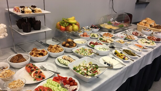 A buffet table with various food items including salads, fruits, and pastries. - Hotel Sokołowska (Nowy Dwor Mazowiecki)