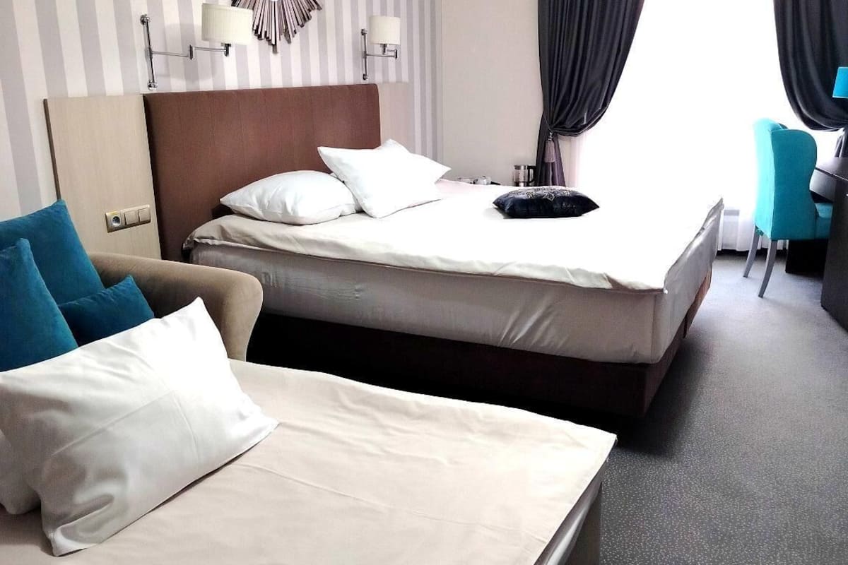 deluxe triple room | in-room safe, individually decorated, desk, laptop workspace