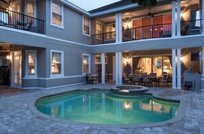 A two-story residential building with a swimming pool, outdoor seating, and a barbecue area. - Villa The Sunshine House 4 Bedroom Reunion (Kissimmee)