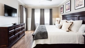 A bedroom with a large bed, a dresser, a flat-screen TV, and a ceiling fan. - Condo Serenity at Cabana Court 3 Bedroom Reunion (Kissimmee)