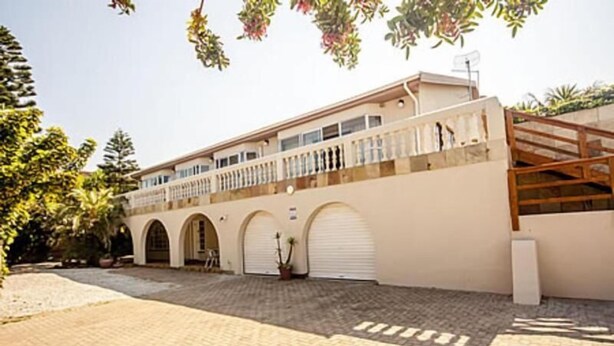 A building with a flat roof, multiple arched doorways, and a balcony with railings. - Bluewater Reservations (Gqeberha (Port Elizabeth))