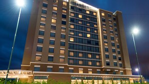 A multi-story hotel with a modern design, featuring a prominent "HYATT PLACE" sign at the top.