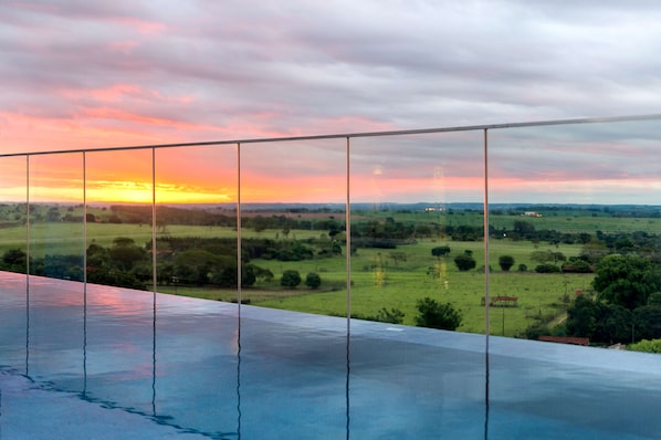 Outdoor pool, open 6:00 AM to 10:00 PM, pool loungers
