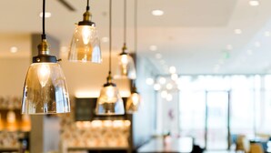 A modern interior with pendant lighting and a bar area.