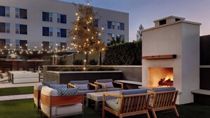 An outdoor seating area with sofas, chairs, and a fire pit. - The Elmore Hotel, DFW Southlake, a Tribute Portfolio Hotel (Southlake)
