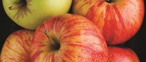 A close-up of several apples with varying colors and patterns.