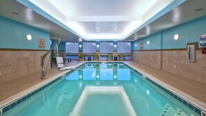 An indoor swimming pool with a clear view of the pool lift and lounge chairs. - SpringHill Suites by Marriott St. Joseph Benton Harbor (Benton Harbor)