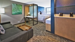 A hotel room with a sofa, a desk, a bed, and a minibar. - SpringHill Suites by Marriott St. Joseph Benton Harbor (Benton Harbor)