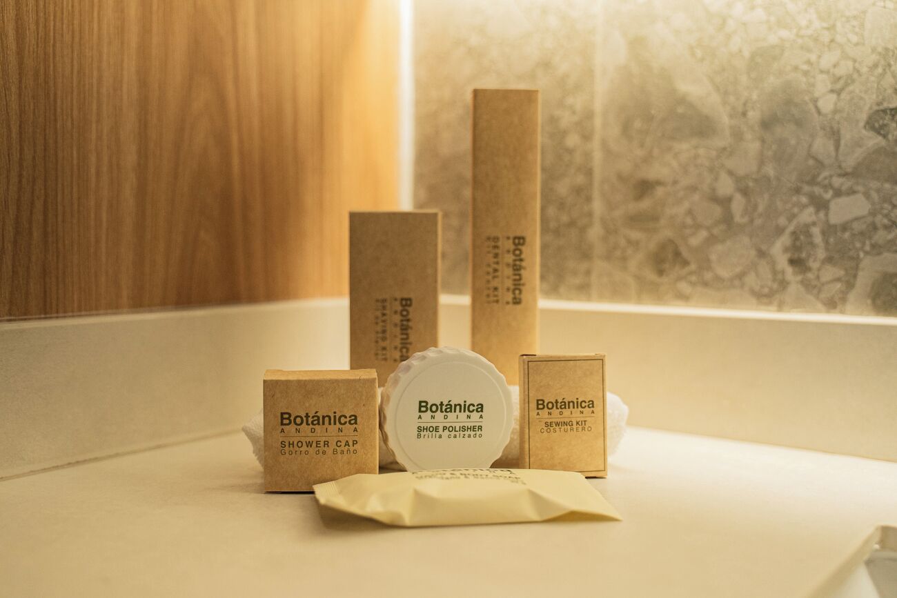 A set of wooden boxes labeled 'Botánica' with different products like shoe polish and sewing kit.