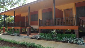 A two-story building with a covered porch and a staircase. - Khunnam Rimtarn Resort (Mae Sai)