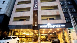 A multi-story hotel with a prominent entrance, a sign for Hotel Majori, and a black car parked in front. - Hotel Major 2 (Jeju City)