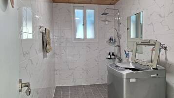 Shower, hair dryer, slippers, towels