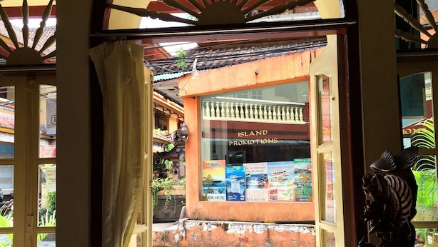 An open doorway leading to a shop with a sign for 'Island Promotions'. - Bali Duta Wisata Beach Inn (Kuta)