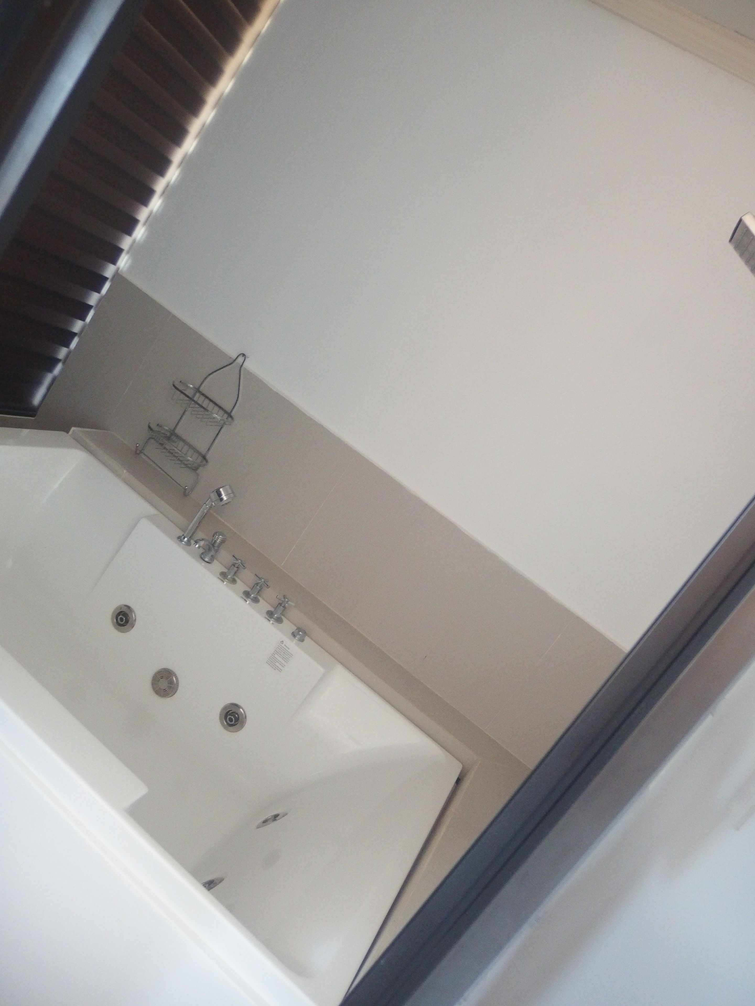 A bathroom with a bathtub, a shower, and a toilet.