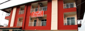 A red building with multiple balconies and windows.