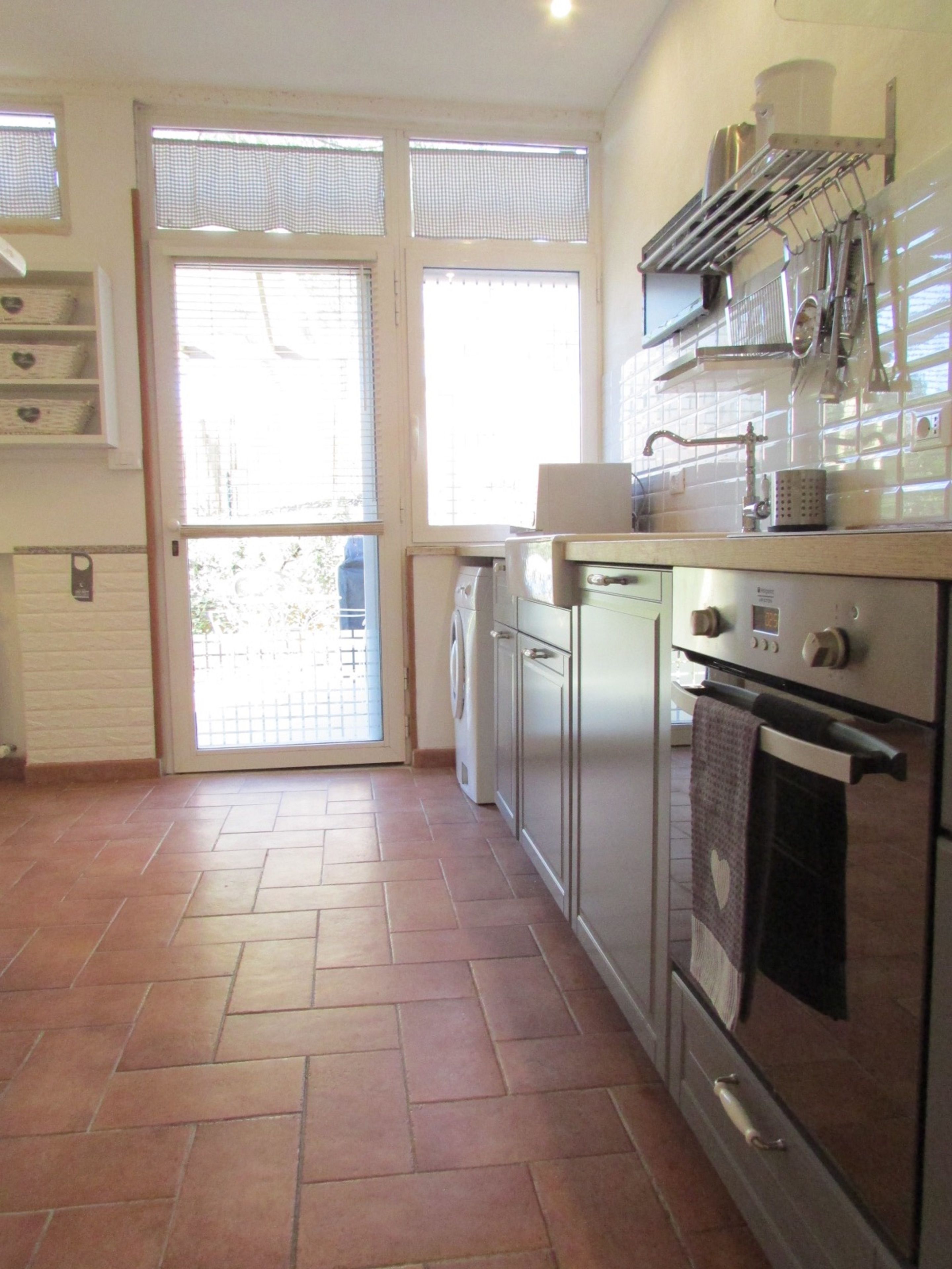 A kitchen with a stove, oven, and a washing machine.