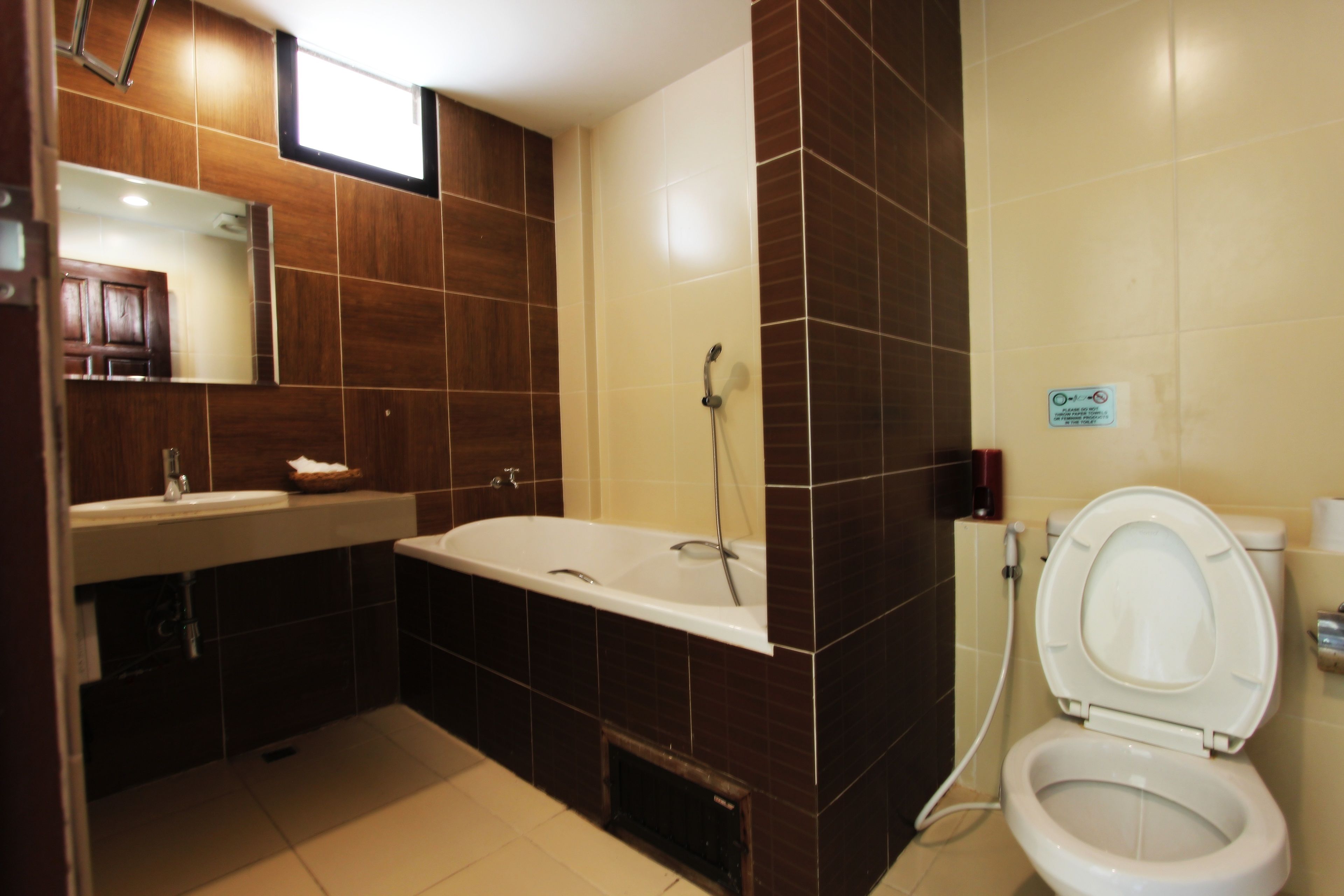 A modern bathroom with a bathtub, toilet, and sink.