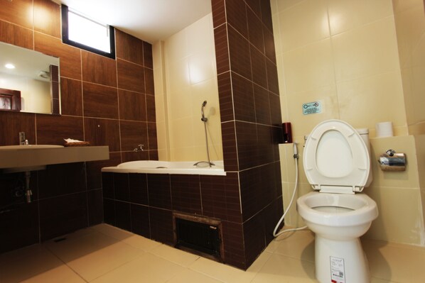 A modern bathroom with a sink, bathtub, and toilet.