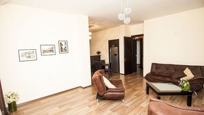 Departamento Confort, 3 habitaciones, para fumadores, vista a la ciudad | Sala de estar | Televisión de pantalla plana de 42 pulgadas con canales vía satélite 