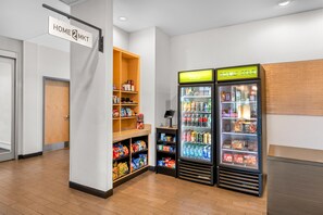 A snack bar with shelves stocked with chips, snacks, and beverages, and two refrigerated display cases labeled 'COLD' and 'REALLY COLD'.