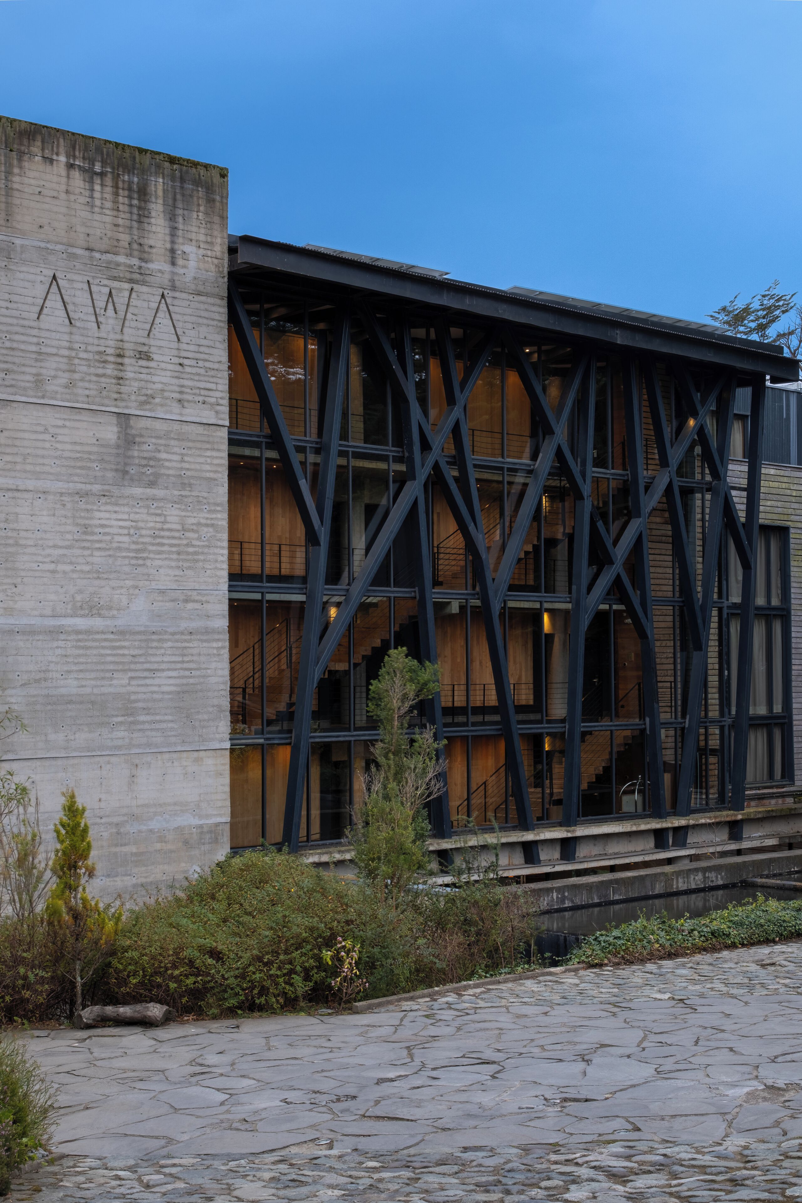A building with a concrete facade and a black metal framework.