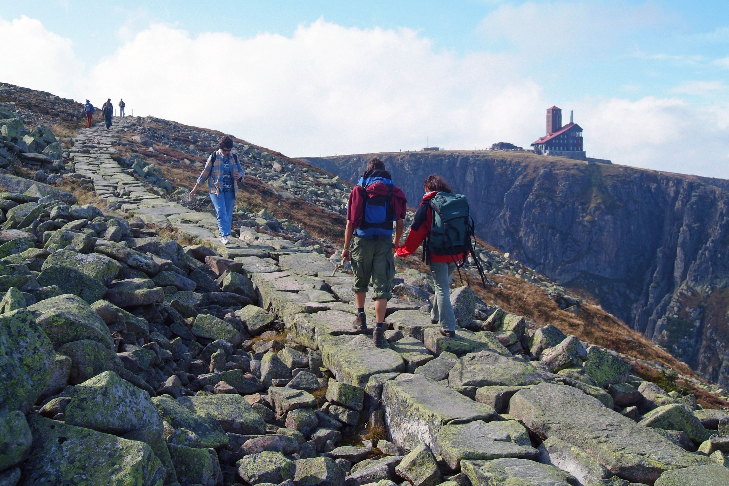 A rocky hiking trail with hikers.