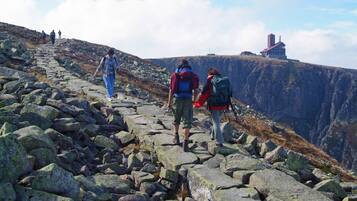 A rocky hiking trail with hikers.