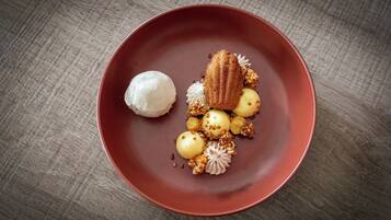 A dessert on a red plate with a wooden table background.