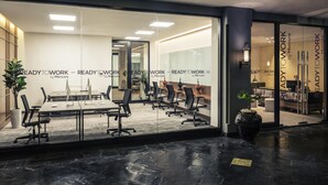 A modern office space with glass walls, a conference table, and multiple chairs. - Mercure Yangon Kaba Aye (Yangon)