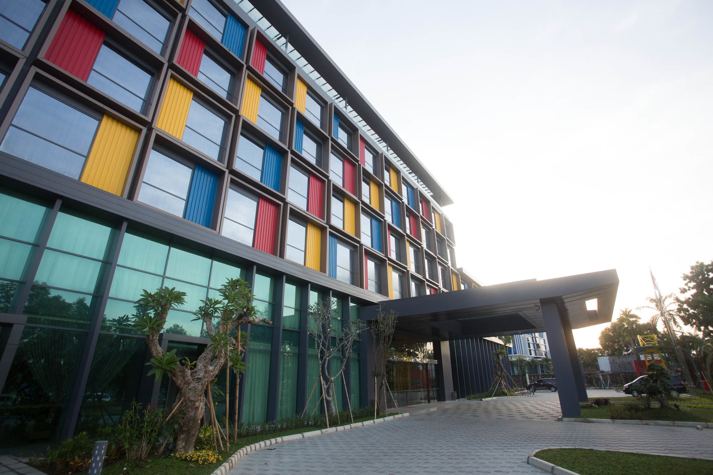A modern building with a glass facade and colorful vertical panels.