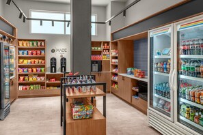A grocery store interior with shelves stocked with snacks, a refrigerated section, and a beverage cooler. - DoubleTree by Hilton Midland West Loop I-250 (Midland)