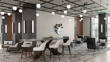 A modern conference room with a long table, white chairs, and a patterned rug.