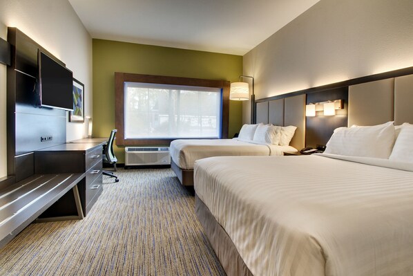 A hotel room with two beds, a desk, a flat-screen TV, and a window with a view of trees. - Holiday Inn Express & Suites Charleston NE Mt Pleasant US17 by IHG (Mount Pleasant)