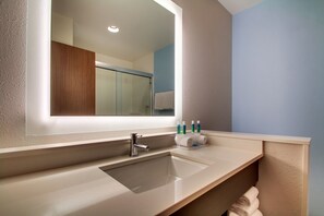 A modern bathroom with a large mirror, a sink, and a towel rack. - Holiday Inn Express & Suites Charleston NE Mt Pleasant US17 by IHG (Mount Pleasant)