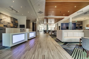 A hotel lobby with reception desks, seating areas, and a wooden ceiling. - Holiday Inn Express & Suites Charleston NE Mt Pleasant US17 by IHG (Mount Pleasant)