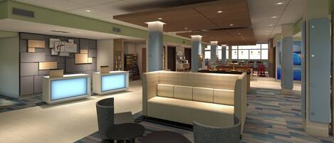 A hotel lobby with a reception desk, seating area, and a view of the dining area.