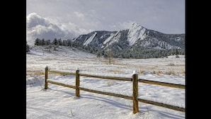 A snow-covered landscape with a wooden fence in the foreground and a mountain in the background. - Holiday Inn Express and Suites Broomfield by IHG (Broomfield)