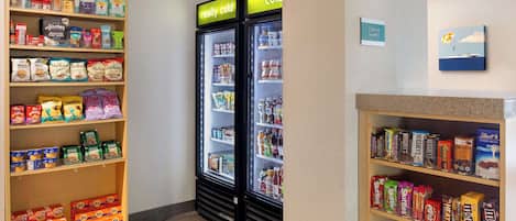 A snack and beverage display area with various packaged foods and drinks.