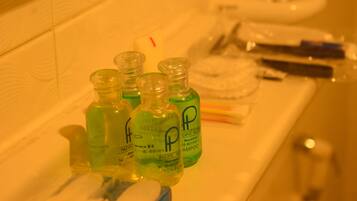 Bottles of Pacific Hotel shampoo and conditioner on a bathroom counter.