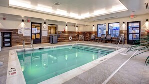 An indoor swimming pool with clear signage, a no diving policy, and a seating area with chairs and a table. - Fairfield Inn & Suites Springfield Holyoke (Holyoke)